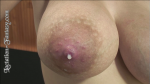 a close up view of a breast full of milk and leaking milk